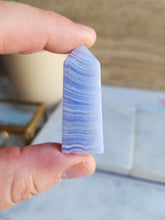 Load image into Gallery viewer, With its gentle energy, Blue Lace Agate fosters tranquillity and emotional balance. It helps you express yourself confidently and opens your heart to compassion
