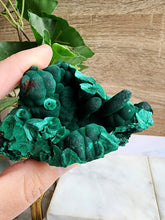 Load image into Gallery viewer, Malachite is a captivating green copper mineral, valued for both its aesthetic appeal and spiritual properties. Known for aiding transformation, it helps clear negative energy, boost intuition, and promote emotional healing, making it an excellent companion for navigating life changes.
