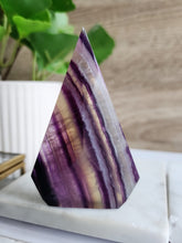 Load image into Gallery viewer,  Uncover Fluorite’s power to boost intuition, focus, and emotional healing. Its calming energy supports mental clarity and spiritual growth, ideal for meditation and enlightenment.
