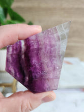 Load image into Gallery viewer, Unlock mental clarity and spiritual insight with Purple Fluorite. This crystal enhances focus, emotional healing, and connection to higher realms, perfect for deepening your spiritual practice
