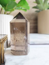 Load image into Gallery viewer, Smoky Quartz is a powerful grounding crystal that clears negativity and fosters emotional stability. Its protective energy promotes calm, clarity, and focus, making it perfect for meditation and personal growth
